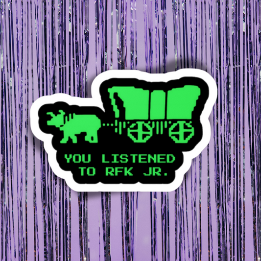 Sticker with a green silhouette of a covered wagon and text on a purple striped background