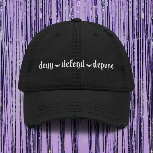 Black cap with text 'deny defend depose' on a purple background