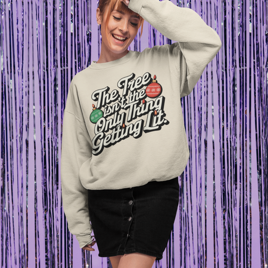 Person wearing a sweatshirt with text and graphics against a purple tinsel background
